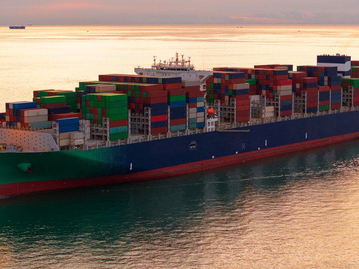 A container cargo ship at sea carrying freight across global trade routes