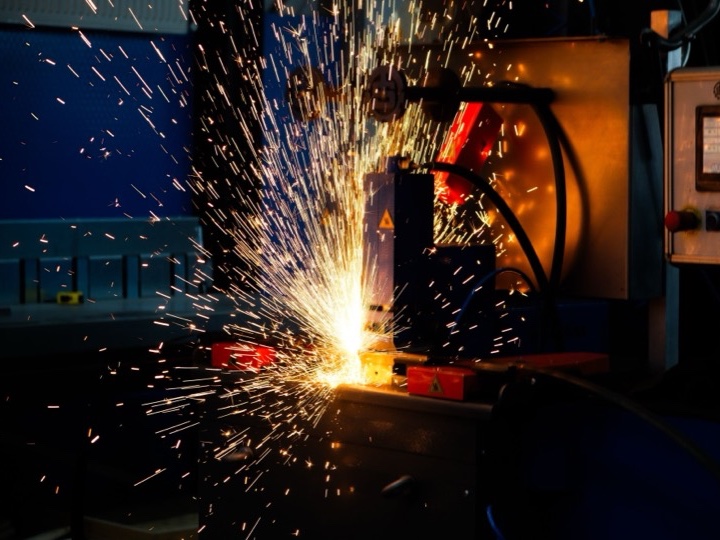 Sparks flying from an automated industrial welding machine